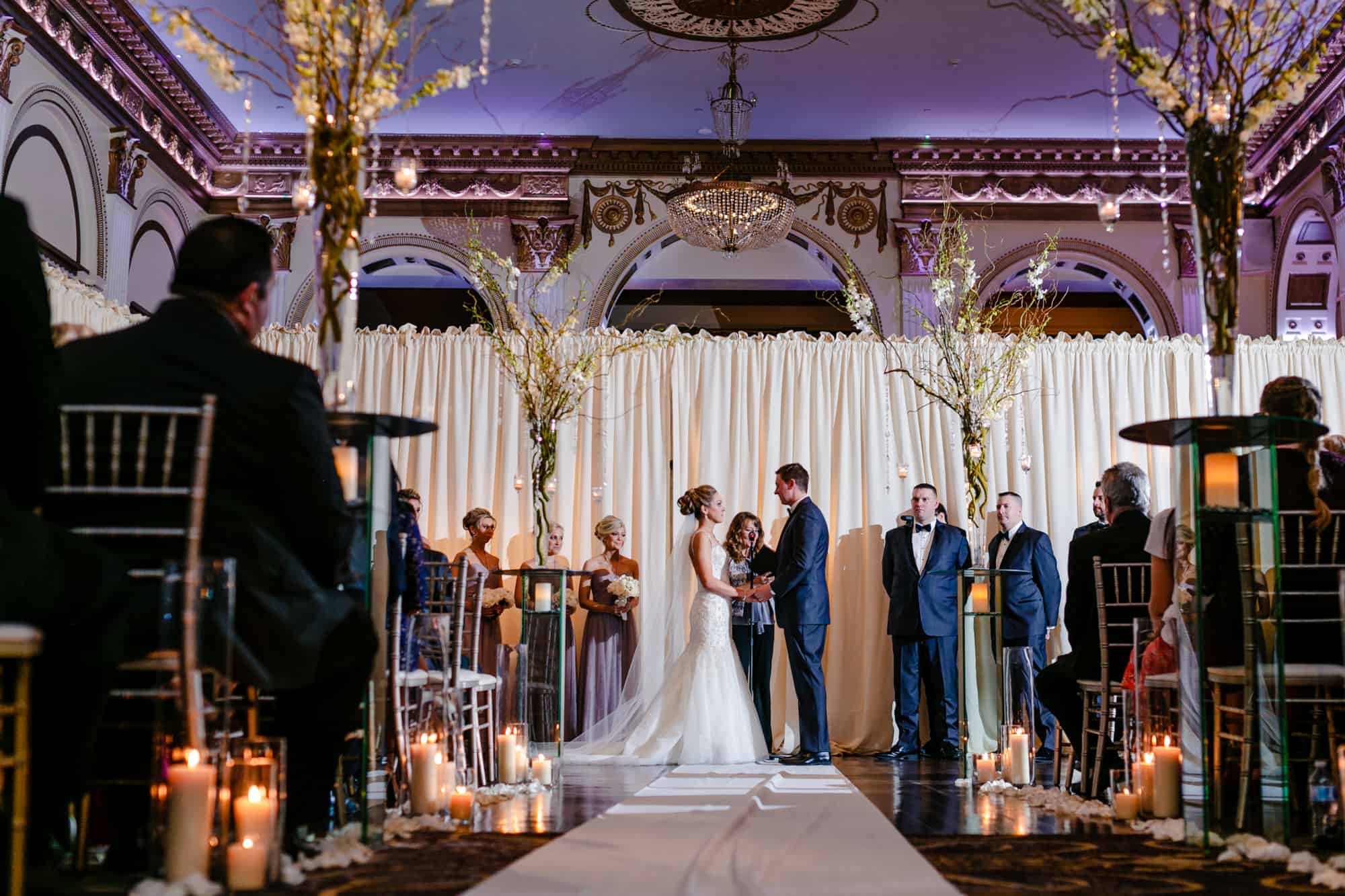 Bride and groom holding hands during ceremony at the Ballroom at the Ben