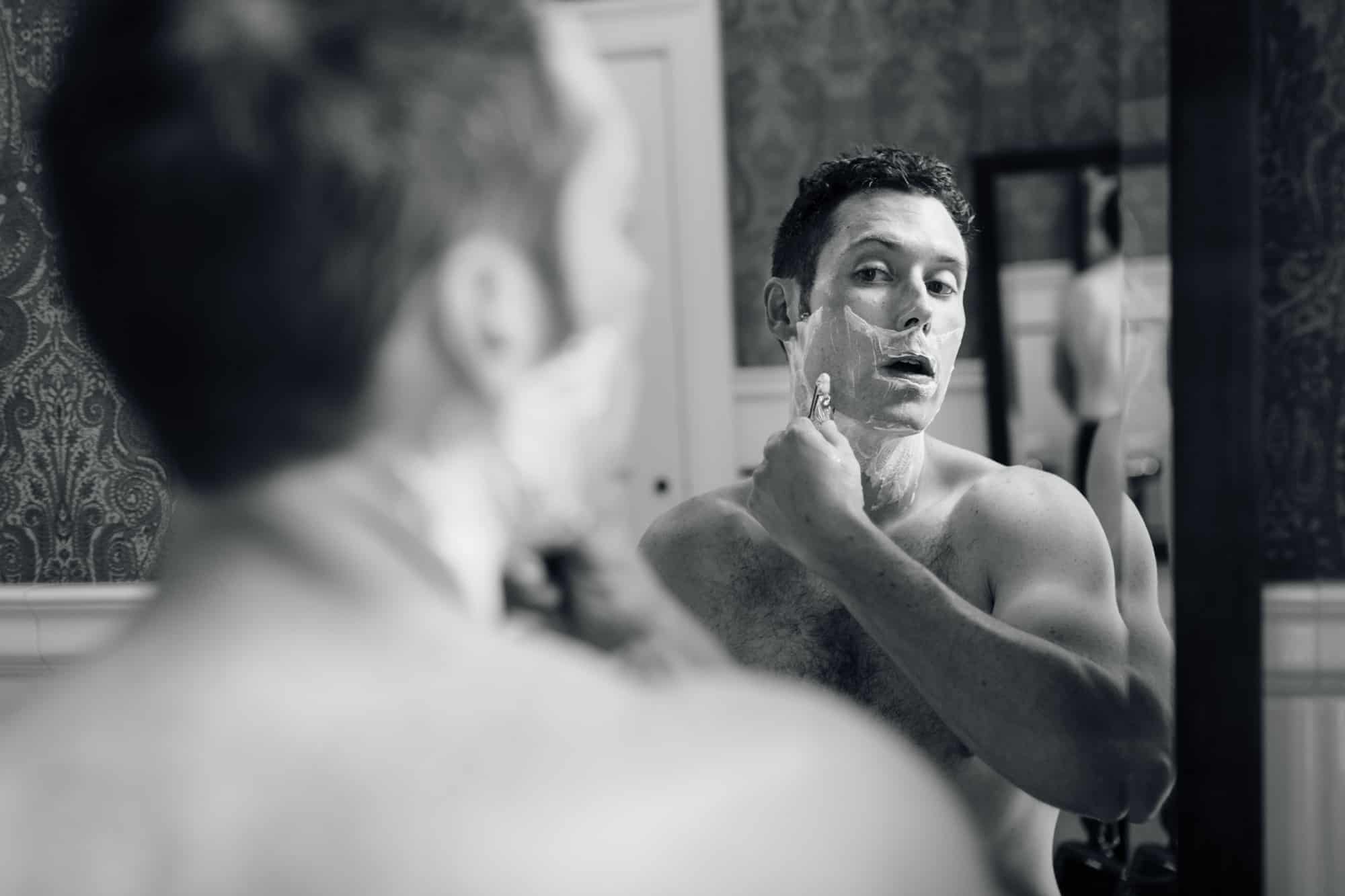 Groom shaving before wedding