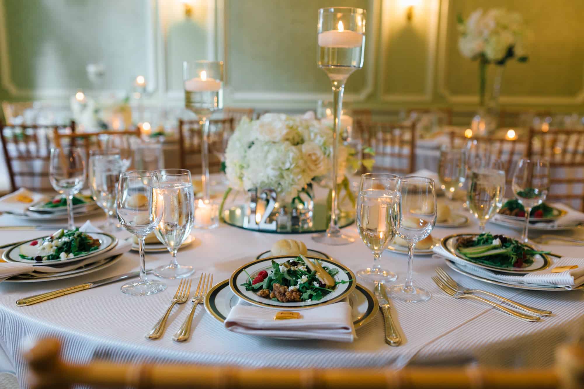 Detailed image of wedding reception menu with salad greens on plates