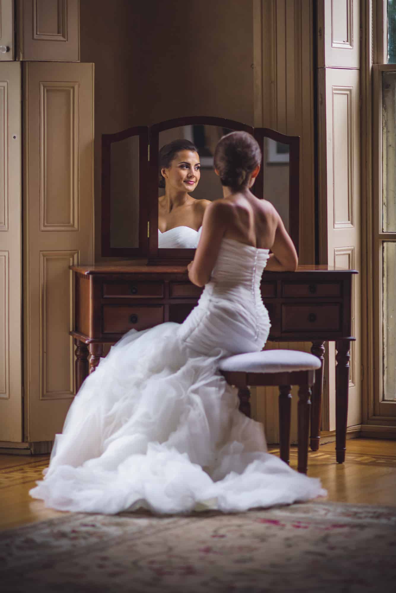 Bride sitting at makeup table at the Glen Foerd Mansion