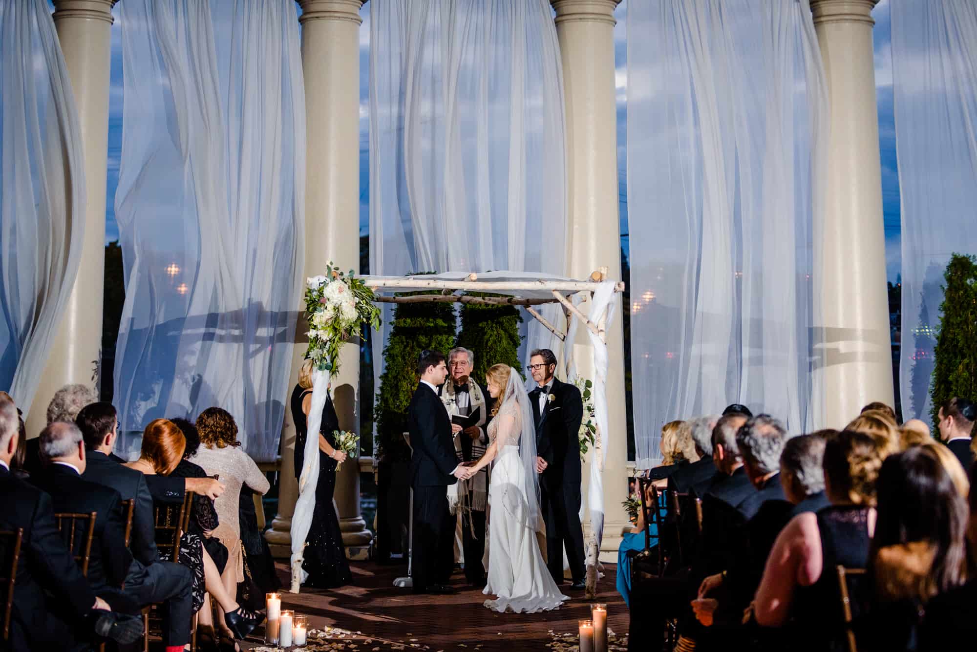 Bride and groom holding hands during ceremony at Water Works in Philadelphia