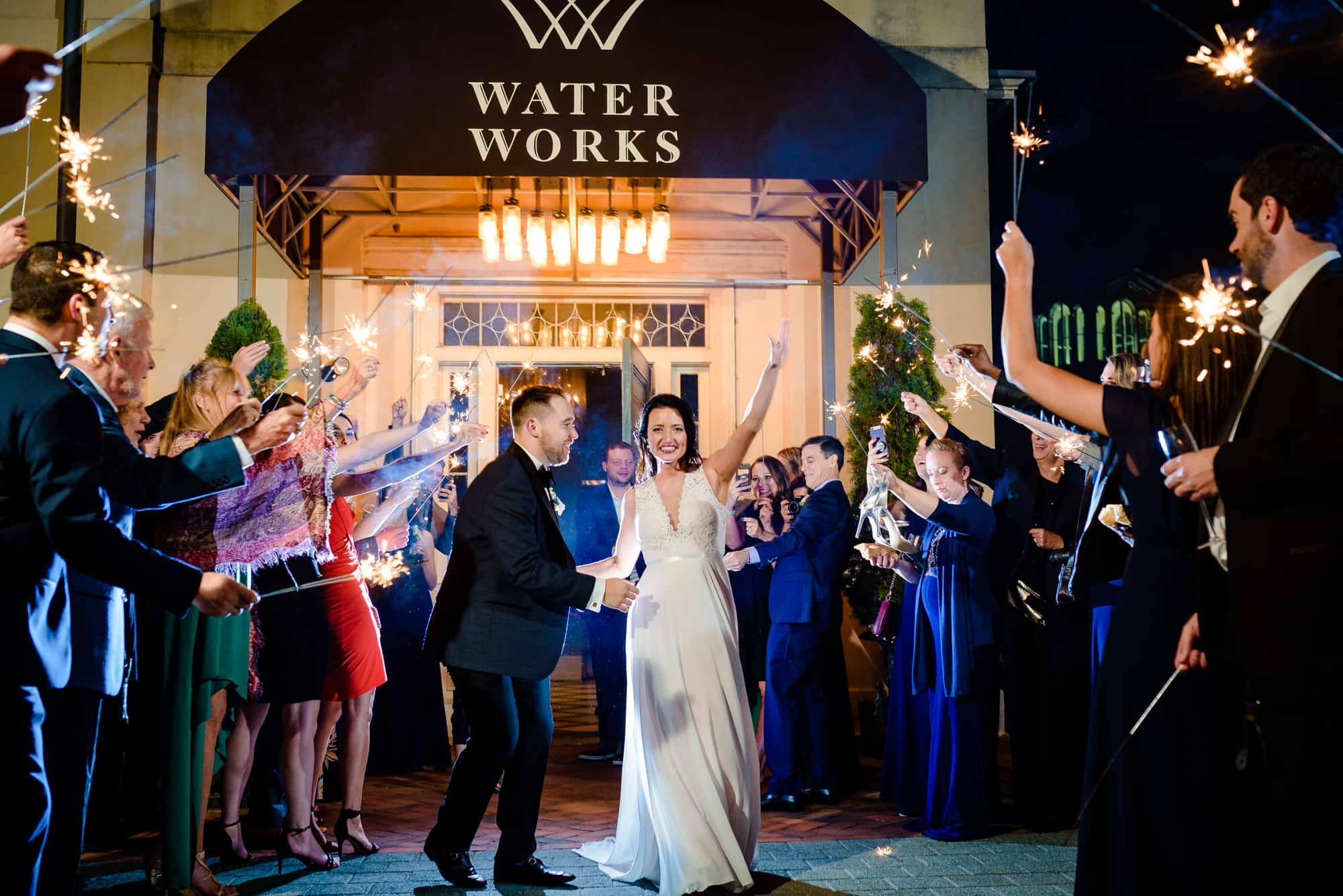 Philadelphia wedding photographer bride and groom exiting reception at the Waterworks in Philadelphia