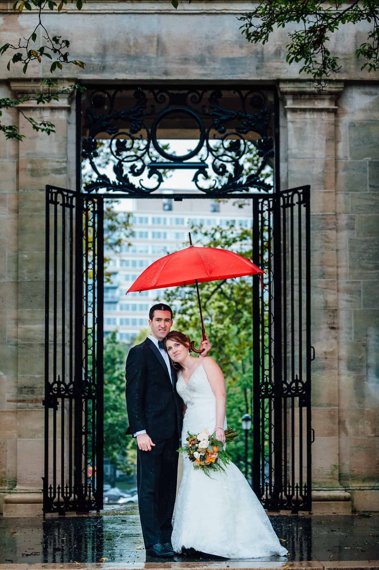 Bride and groom with red umbrella at the Rodin Museum
