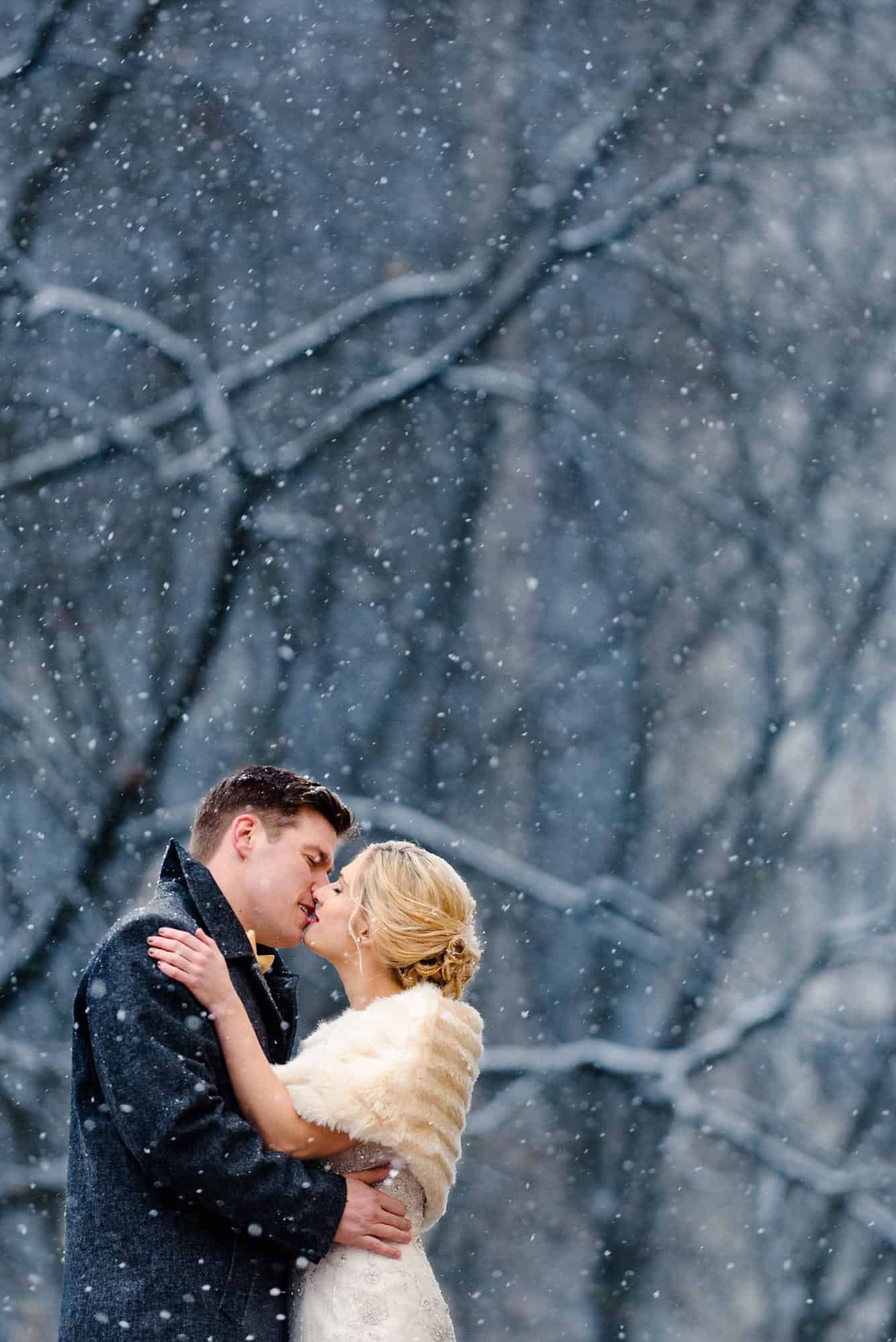 Bride and groom kiss during snow storm in Old City Philadelphia
