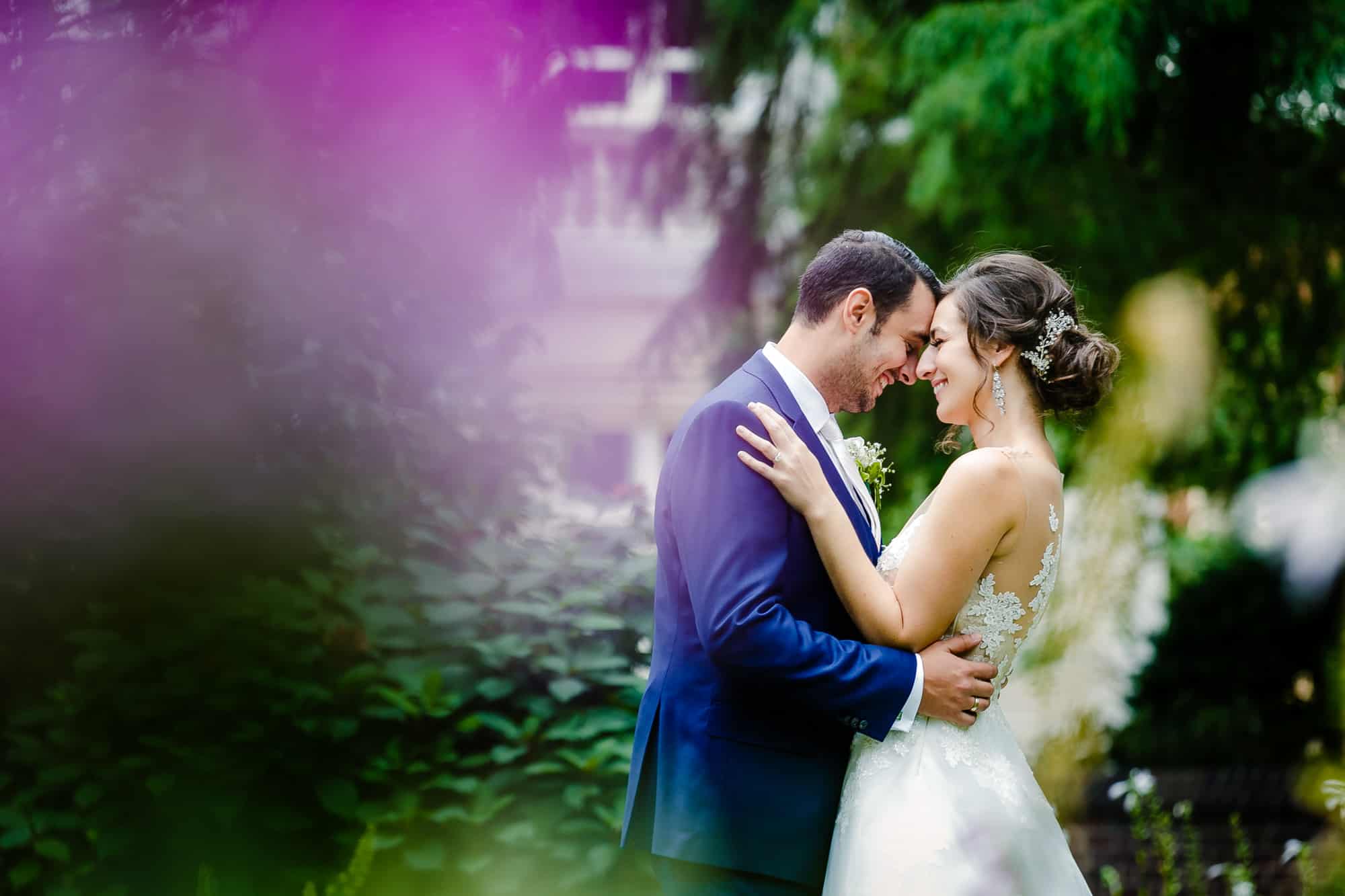 Bride and groom embracing in Washington Square Park
