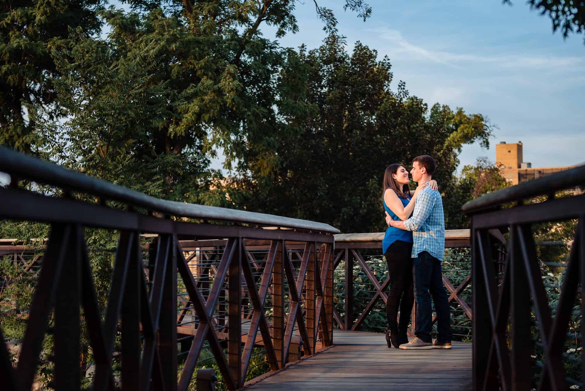 enagagement shoot, couple embracing each other on a bridge