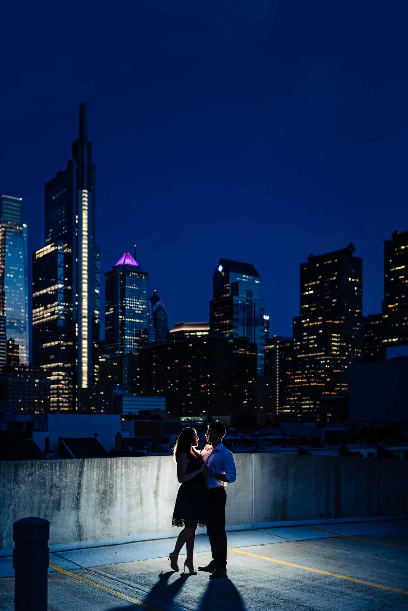 couple dancing on rooftop at night