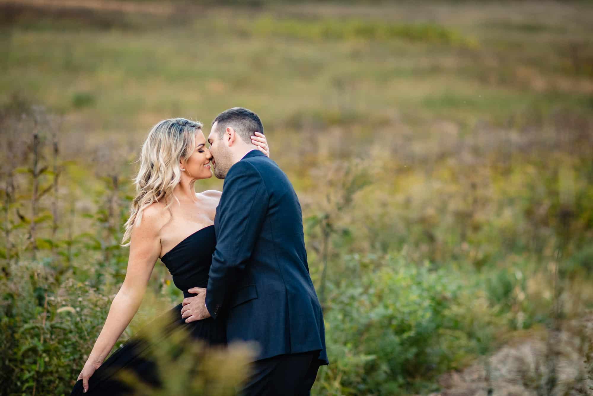 couple posing for their e-session at the Large and Small Lakes area of longwood gardens