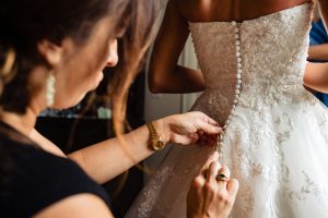 Ritz Carlton Philadelphia Wedding|bride being buttoned by Gina Sole of Instyle Planners