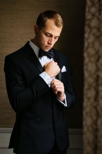 Ritz Carlton Philadelphia Wedding|groom in hotel suite adjusting cufflinks