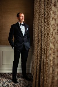 Ritz Carlton Philadelphia Wedding|groom in hotel suite looking out window