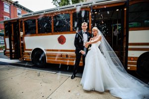 Ritz Carlton Philadelphia Wedding|bride and groom spraying champagne on street