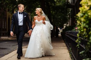 Ritz Carlton Philadelphia Wedding|bride and groom holding hands walking down street