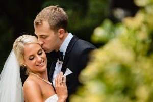Ritz Carlton Philadelphia Wedding|groom kissing brides cheek