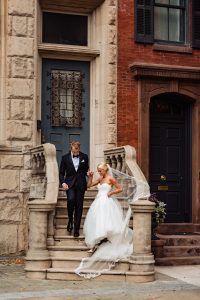 Ritz Carlton Philadelphia Wedding|bride and groom holding hands walking down stairs