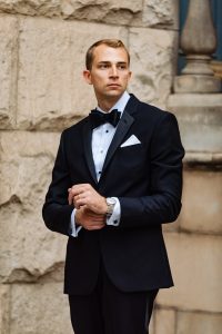 tight shot of groom adjusting watch looking off camera
