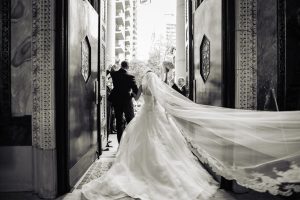 St. Patricks Church|bride and groom exiting church waving to guests shot from behind