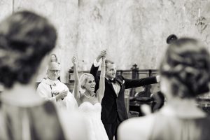St. Patricks Church|bride and groom raising their arms with excitement after ceremony is over