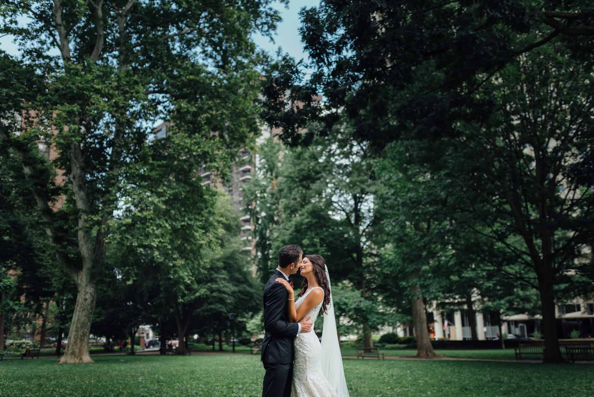 Bride and groom kiss in Washington Square Park