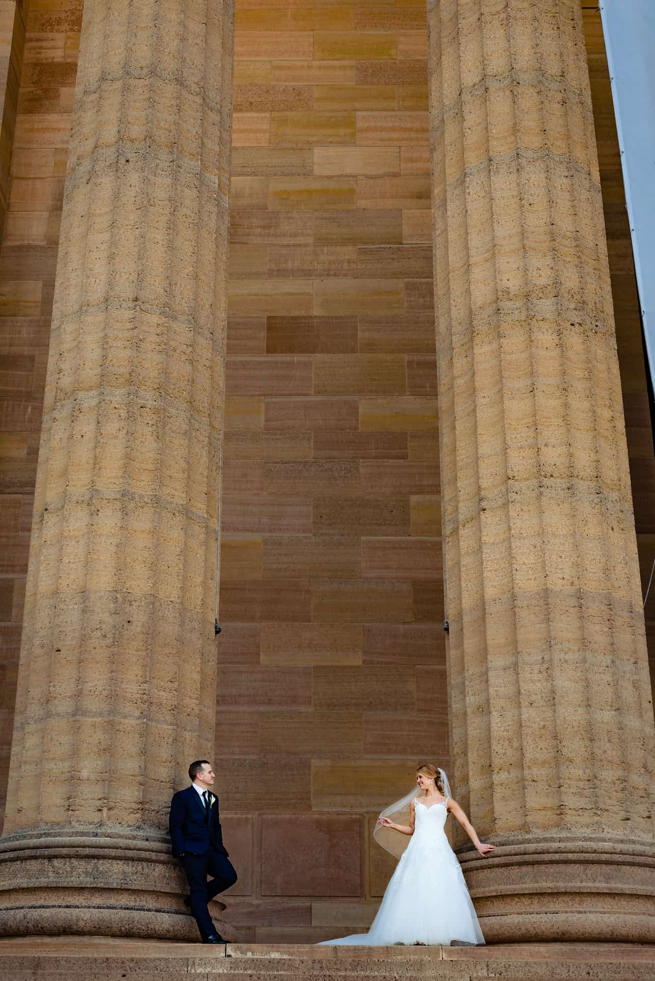 Bride and groom posing on the steps of the Philadelphia Museum of Art