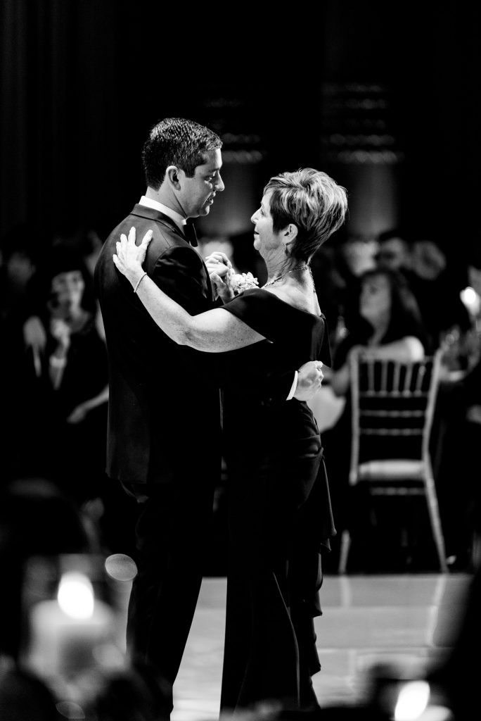 groom and his mother dancing black and white shot