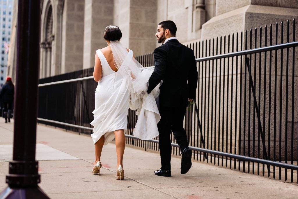 Bride and groom walking in city
