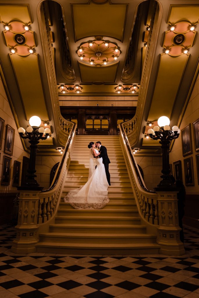 Bride and groom kiss on stairwell