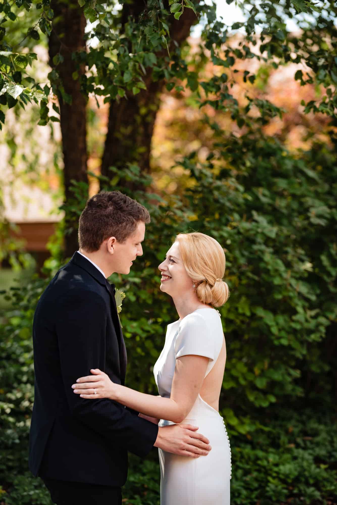 bride and groom smiling at each other