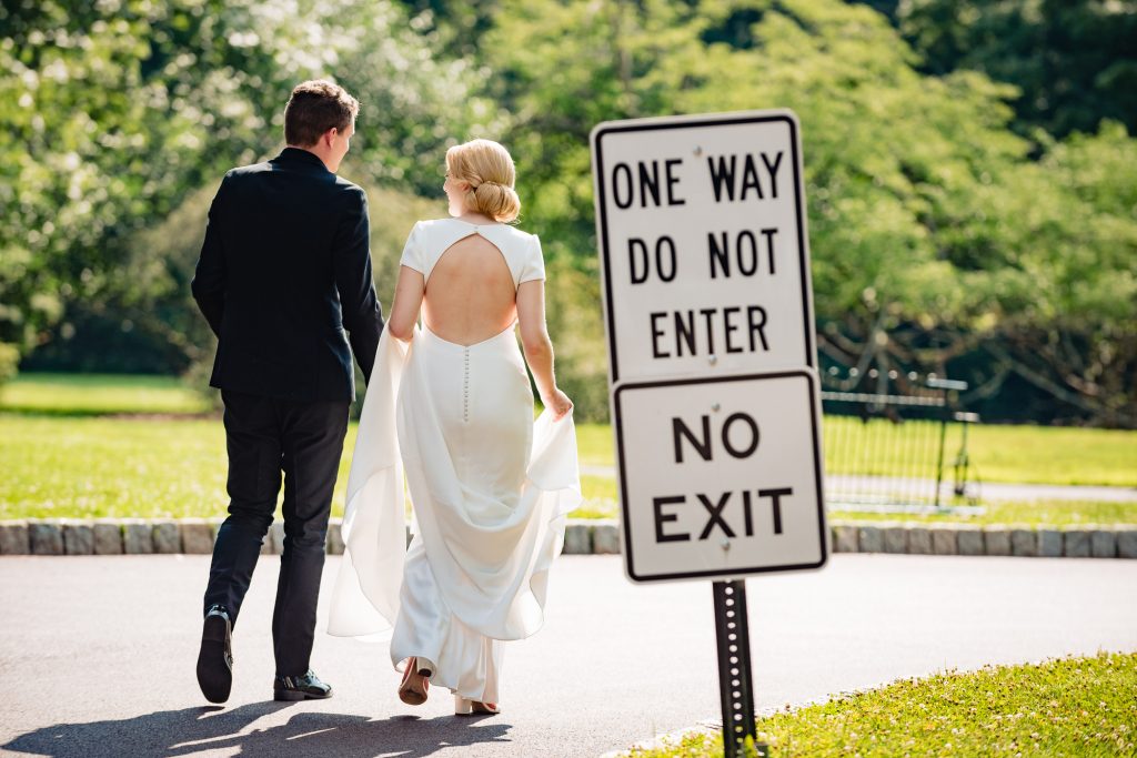 bride and groom walking by do not enter sign at the Morris Arboretum