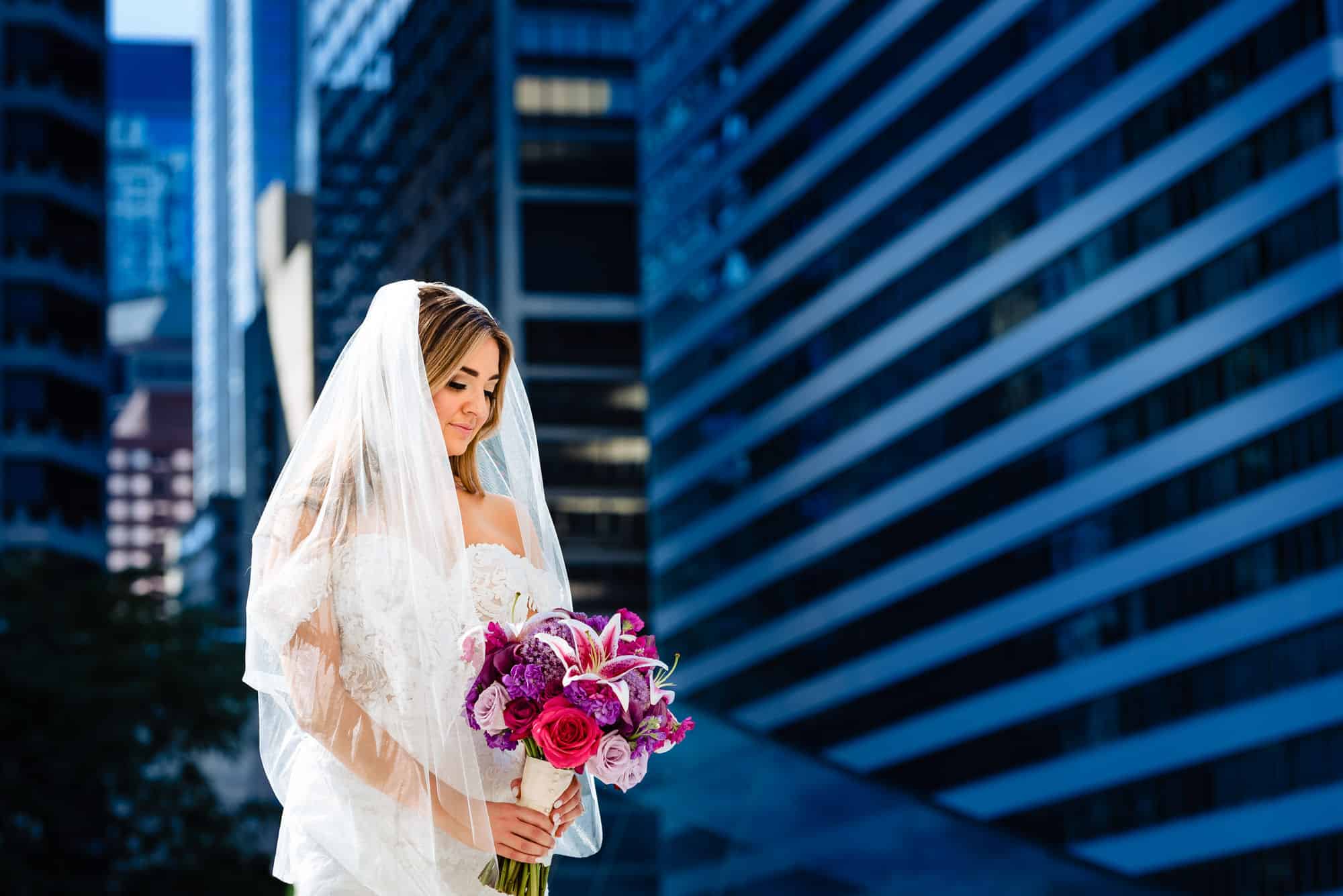 bride holding her bouquet outside the City hall