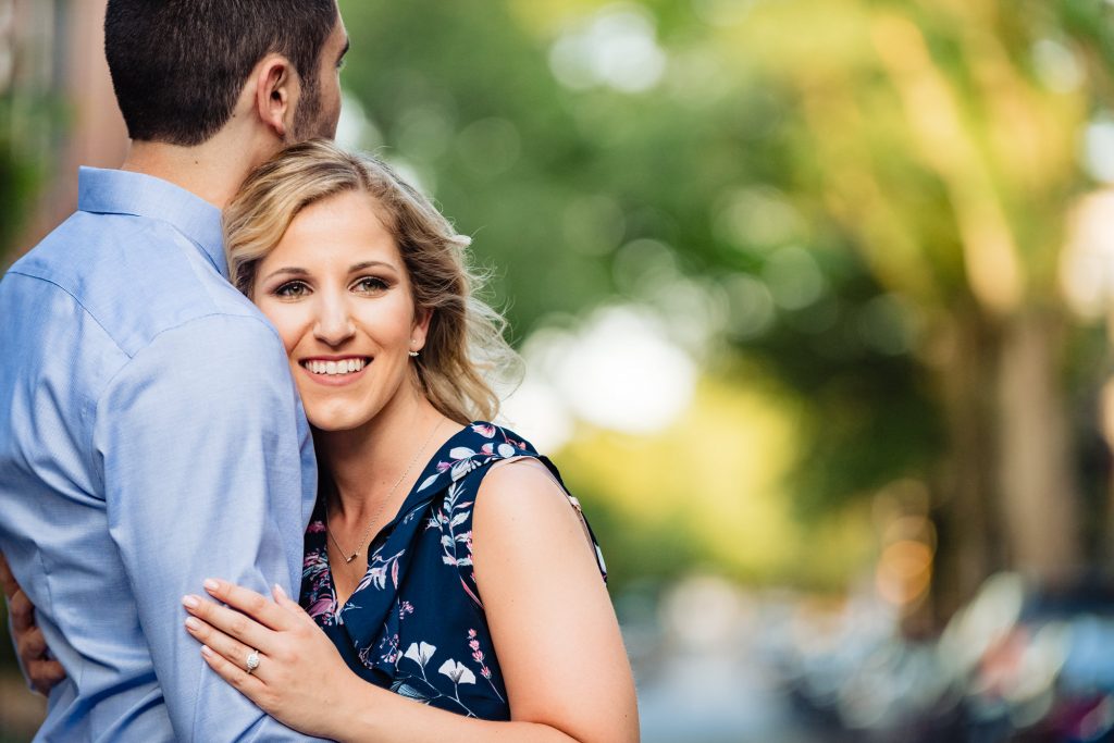 bride-to-be smiling as the couple hugs
