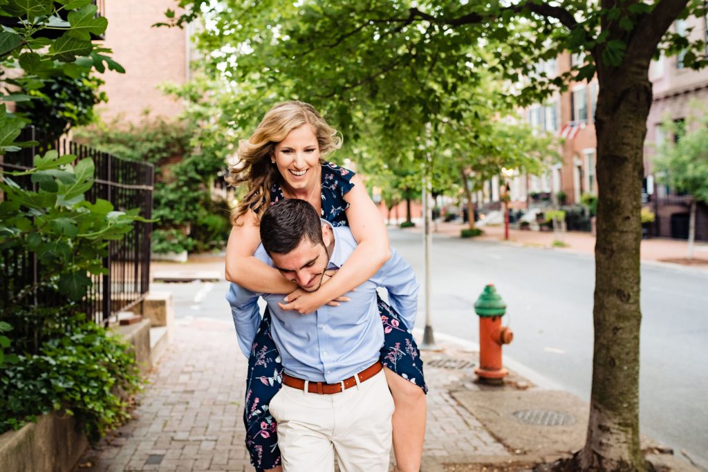 man carrying woman for their old city philly eshoot