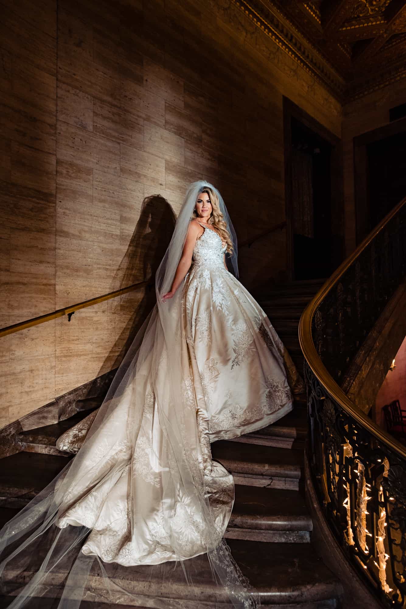 a curvy bride on staircase