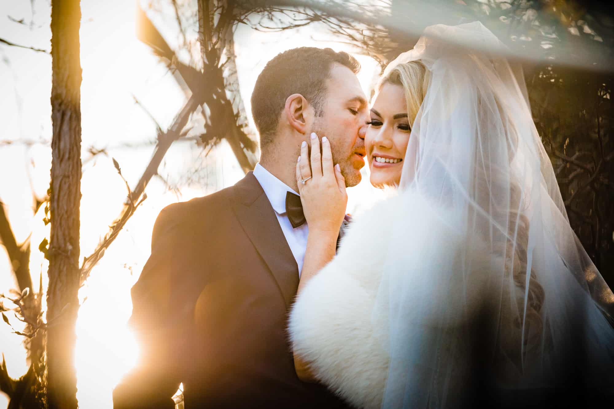 bride and groom poses for the camera