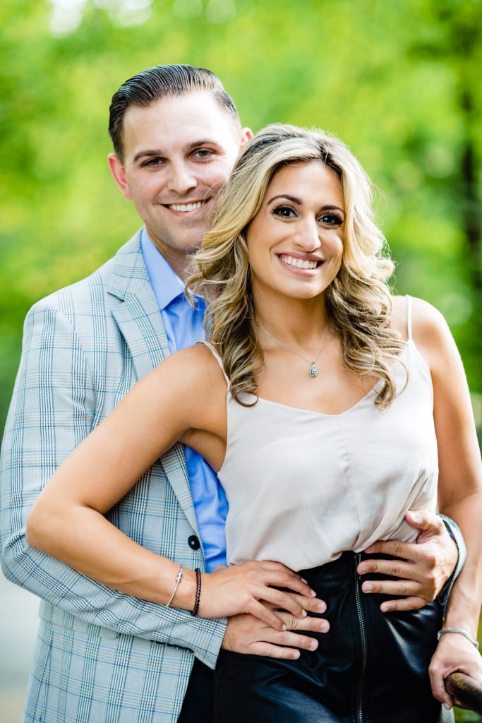 couple smiling and facing the calera during their central park eshoot
