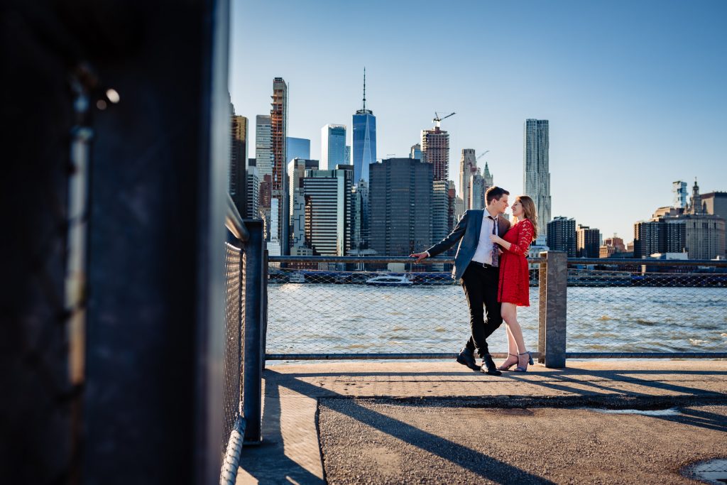 couple embracing playfully on pier in DUMBO Brooklyn