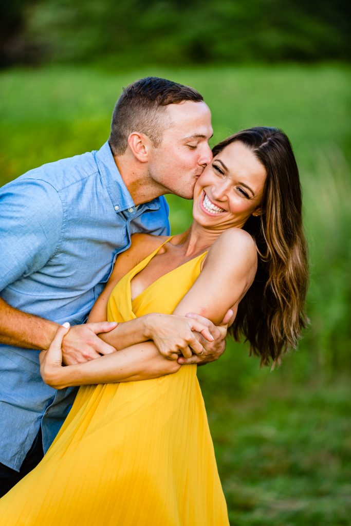 candid shot of man kissing his fiance's cheek