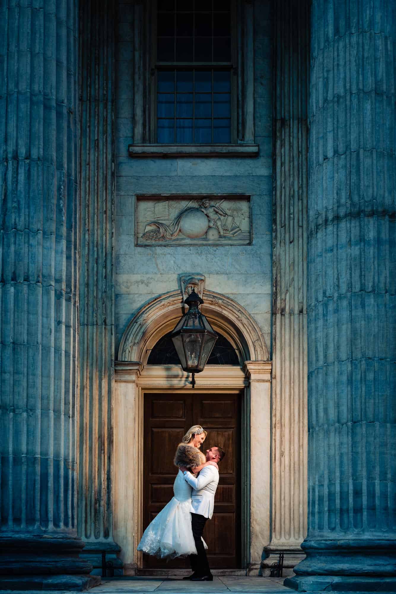 Long shot of the groom carrying the bride