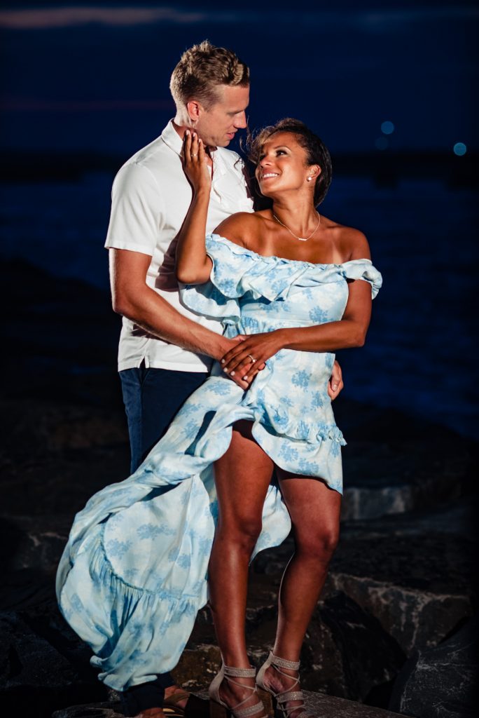 tiff & kyle staring at each other on the beach at night