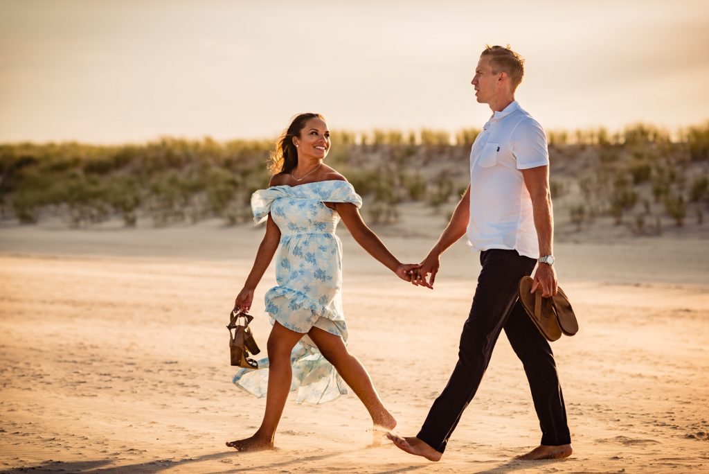 tiff staring at kyle on the beach engagement shoot
