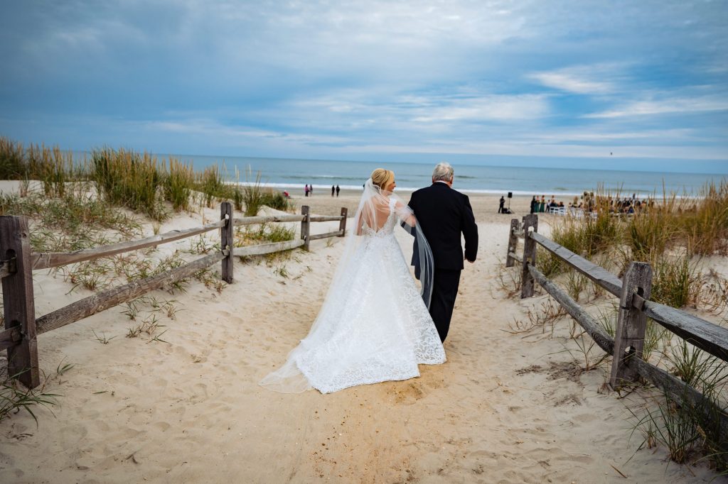 bride's entrance with her father during her beach wedding