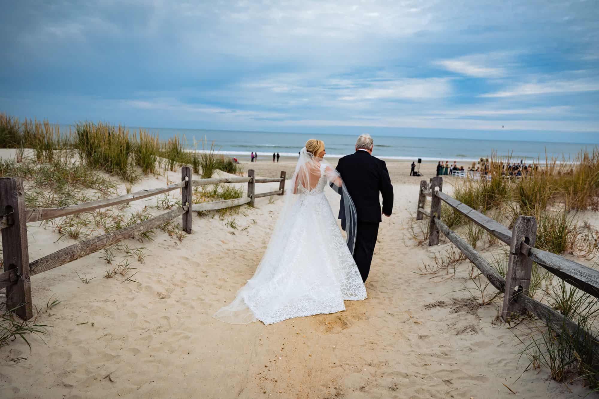 bride's entrance with her father during her beach wedding