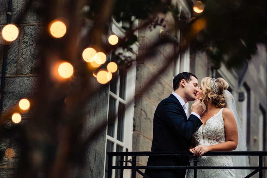 bride and groom leaning in for a kiss