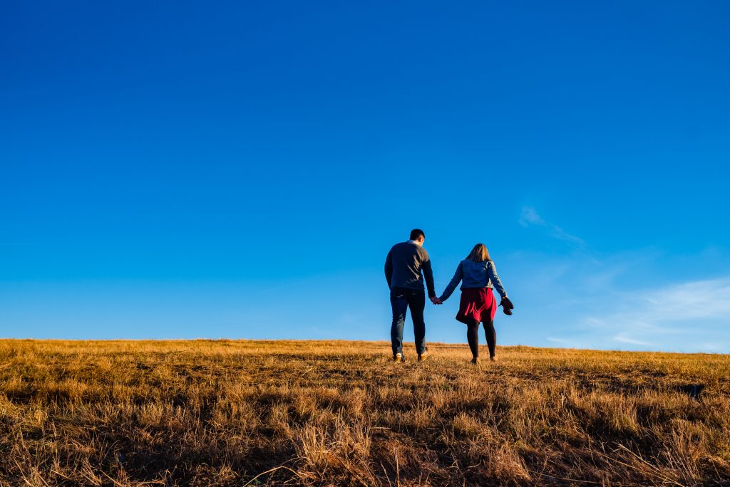 back shot of couple holding hands at valley forge national historic park