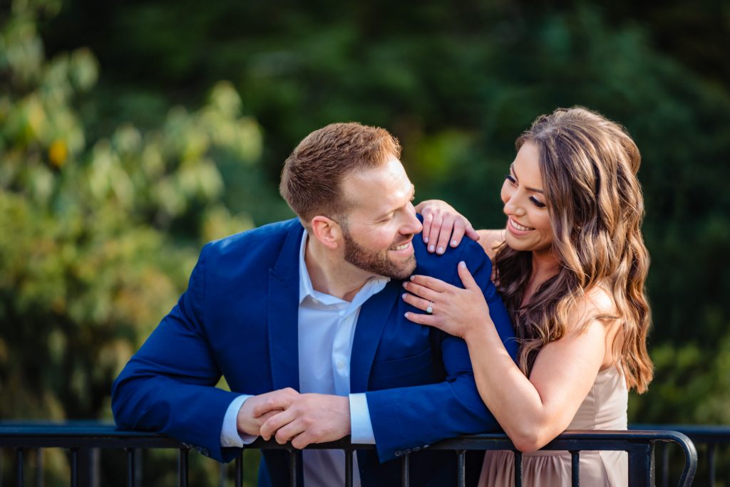 couple embracing and smiling during their couple kisses for their Longwood Gardens Spring e-session