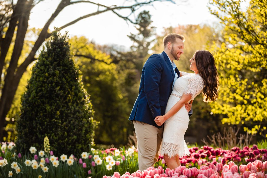 couple taking a pose among a sea of tulips during their Longwood Gardens Spring e-session