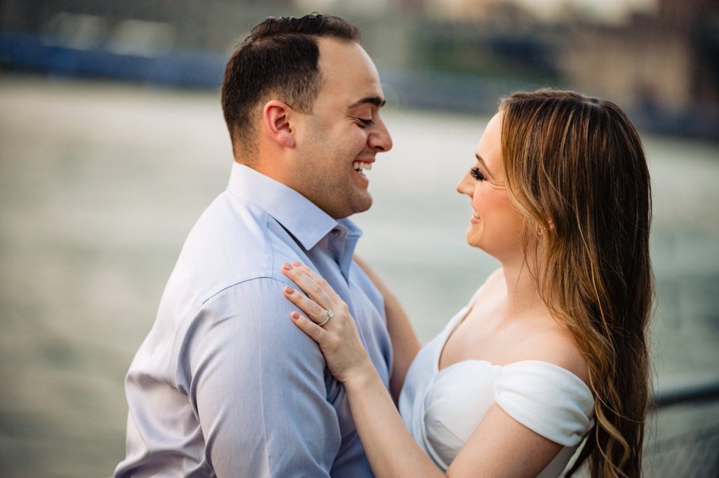 couple taking a pose during their couple kisses for their Brooklyn Bridge park e-session