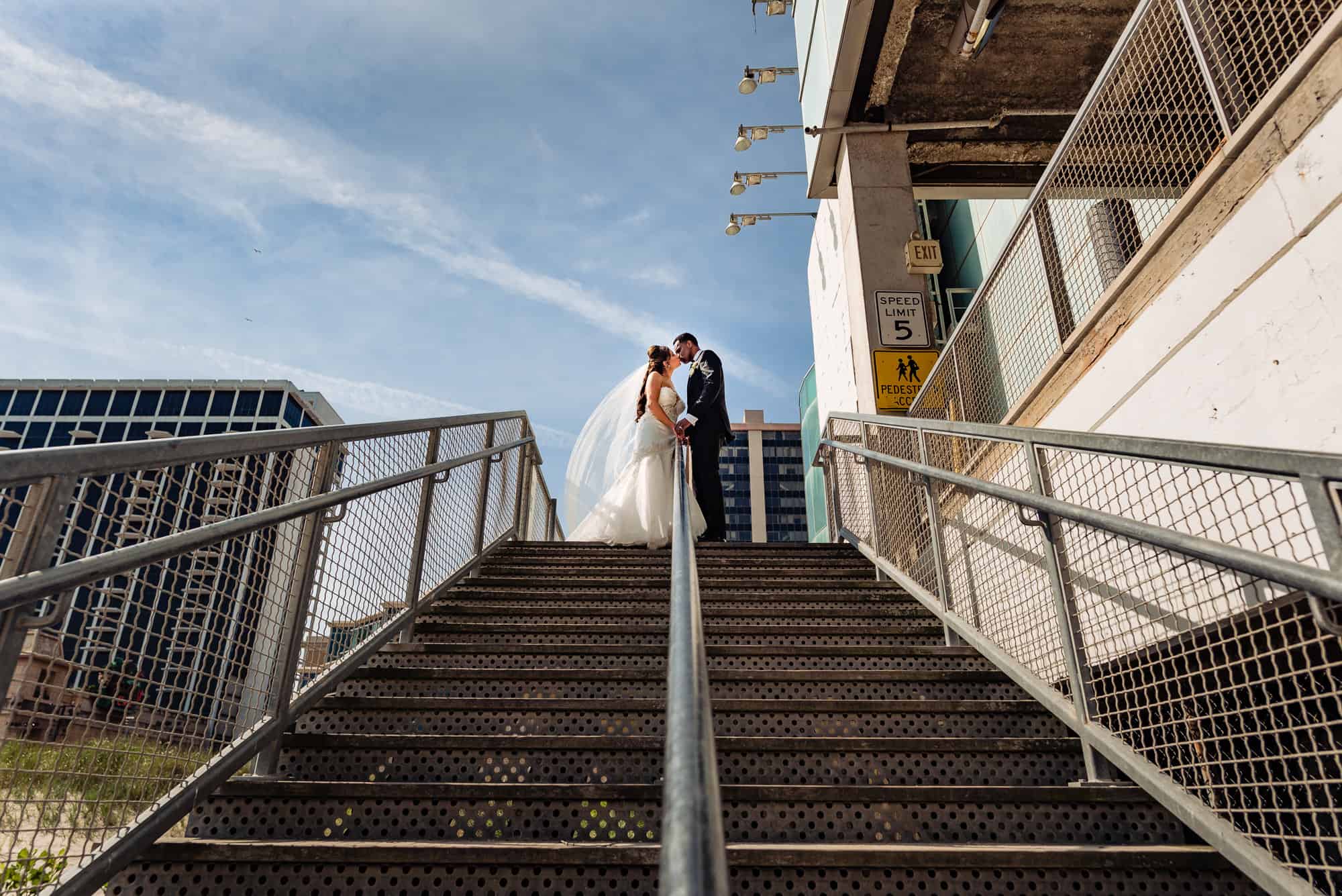 bride and groom taking a pose on a stair before the wedding ceremony