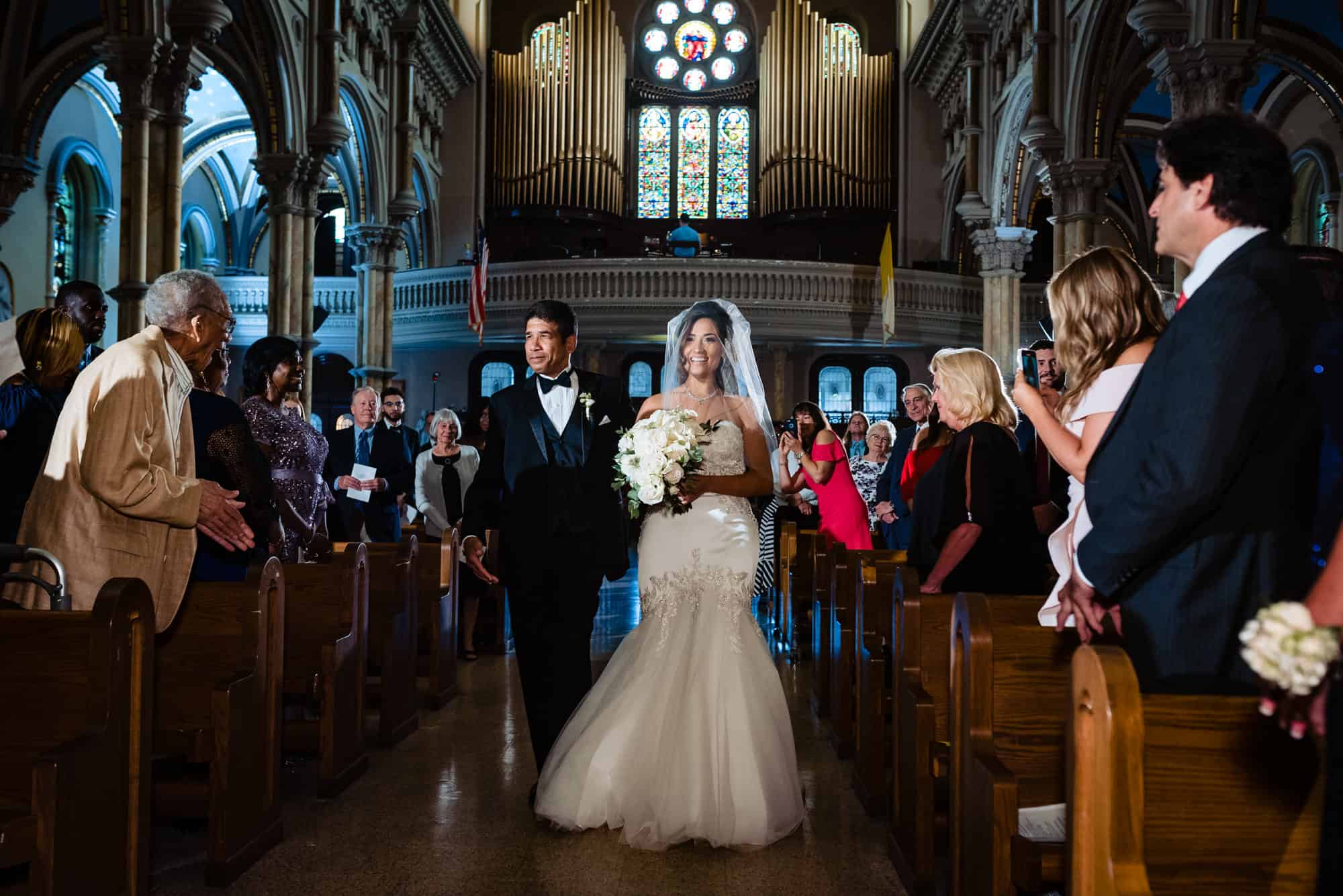 bride walking down the aisle with her father