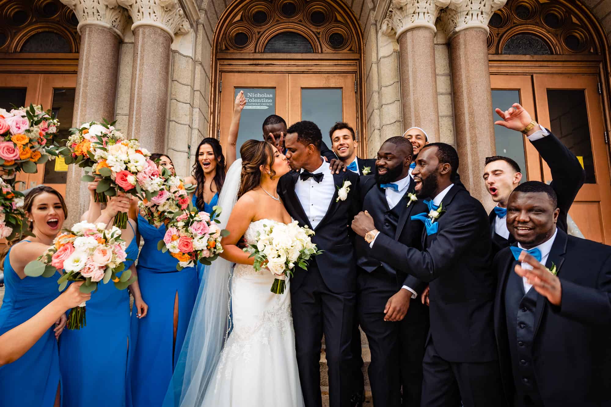 the newlyweds kissing in their ceremonial exit